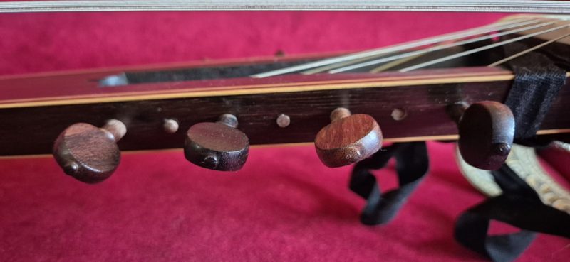 Close-up of rosewood tuning pegs on Jaume Bosser concert theorbo pegbox