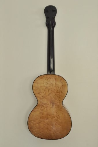Back view of Thibouville-Lamy romantic guitar showing the beautifully figured curly maple back and black lacquered neck