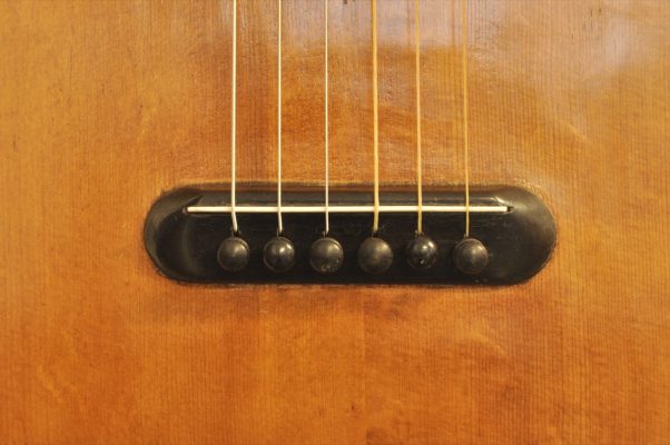 Ebony bridge with bone saddle and ebony string pins on Thibouville-Lamy French romantic guitar