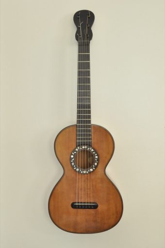 Front view of a French romantic guitar by Jérôme Thibouville-Lamy circa 1870 showing spruce top and mother-of-pearl rosette