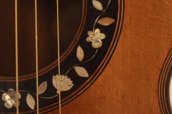 Close-up of engraved mother-of-pearl flowers and leaves showing fine craftsmanship on Thibouville-Lamy guitar rosette