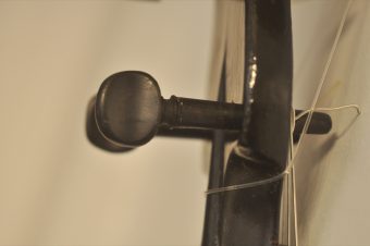 Close-up of granadillo tuning peg on Thibouville-Lamy French romantic guitar headstock