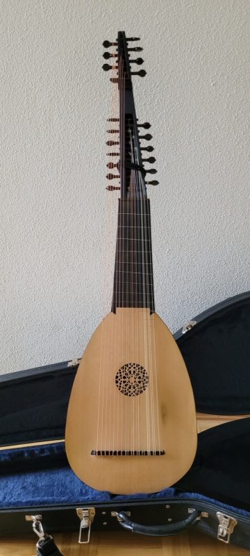 Full-length front view of an archlute by Mateo Baldinelli showing spruce soundboard, carved rosette, and extended double pegbox