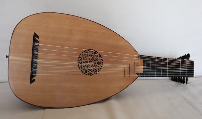 Front view of an 8-course renaissance lute by Le Luth Doré, Molinaro model, showing the spruce soundboard with carved rosette and ebony bridge