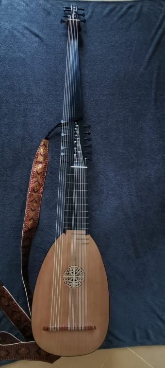 Front view of a 14-course archlute by Knud Sindt, showing the cedar top, carved spruce rosette, ebony fingerboard and extended theorbo-style pegbox.