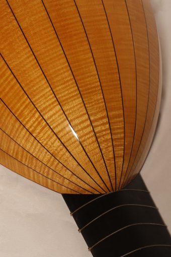 Back of the Chiara Frisio Renaissance lute showing the flamed maple ribs with dark spacers and the ebony-veneered neck heel