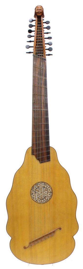 Front view of a 1973 Robert Hadaway bandora with festooned spruce body, carved rosette, fan-shaped fingerboard and human-head pegbox