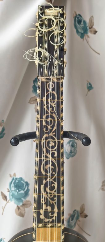 Ebony fingerboard and pegbox of a Stephen Barber baroque guitar with elaborate custom mammoth ivory scrollwork inlay