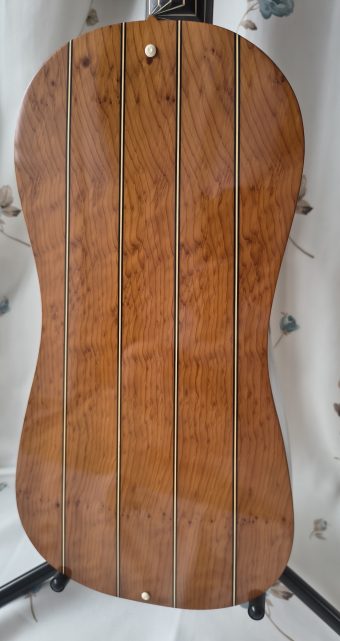 Back of a Stephen Barber baroque guitar in beautifully figured yew with multiple ribs separated by ivory spacer lines