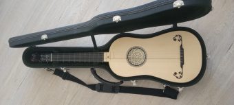 Front view of a Karl Kirchmeyr baroque guitar after Jean Voboam 1687, spruce soundboard with carved parchment rosette