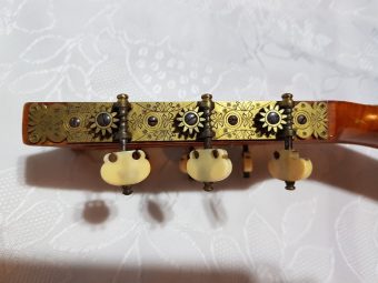 Second view of the floral engraved Baker tuning machines and ivory peg heads on a Louis Panormo guitar
