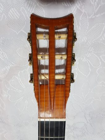 Figured maple slotted headstock of an 1849 Louis Panormo guitar with engraved Baker tuners and ivory peg heads