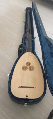 Full view of a 14-course Anders Ahlborg theorbo in its Kingham case, spruce top with triple rosette and extended bass pegbox