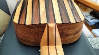 Detail of the neck heel joint and the fluted back ribs in alternating dark and light wood on the César Arias baroque guitar