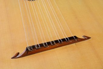 Close-up of the bridge of the Jaume Bosser Renaissance lute with the strings tied on and the fine-grained spruce top