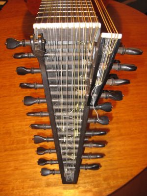 Bent-back pegbox and bass rider of the Hans Jordan baroque lute with turned ebony pegs and the extended bass courses