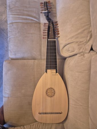 Full front view of a 13-course baroque lute (swan-neck) by Hans Hermann Herb (2009) with light soundboard, carved rosette, extended neck and second pegbox