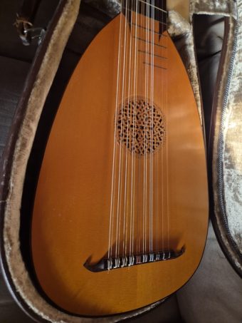Close-up of the varnished soundboard of the baroque lute by Jacob van de Geest (1977), with its carved rosette and bridge