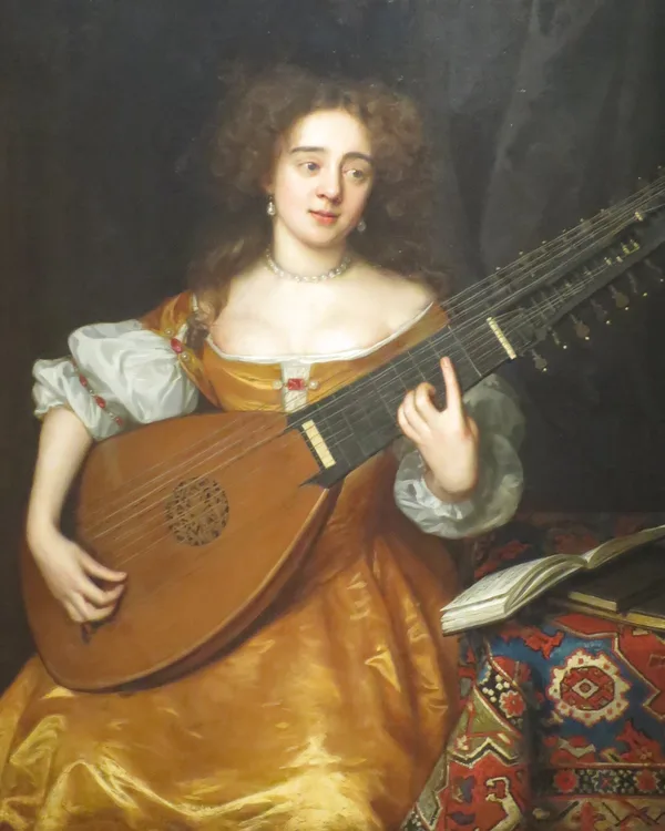 Lady in a golden silk dress playing a theorbo beside a book and a patterned carpet