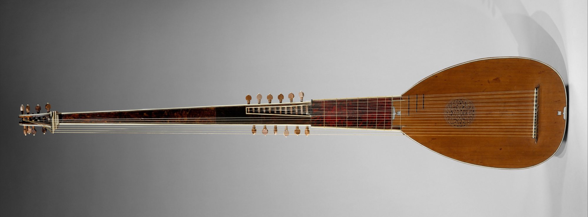 Roman archlute lying horizontally: lute body, short fretted neck and a very long extension for the diapasons