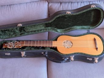 Asier de Benito vihuela lying in its open Manzano carrying case with green plush lining